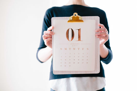 Photo of a Woman Holding a Calendar