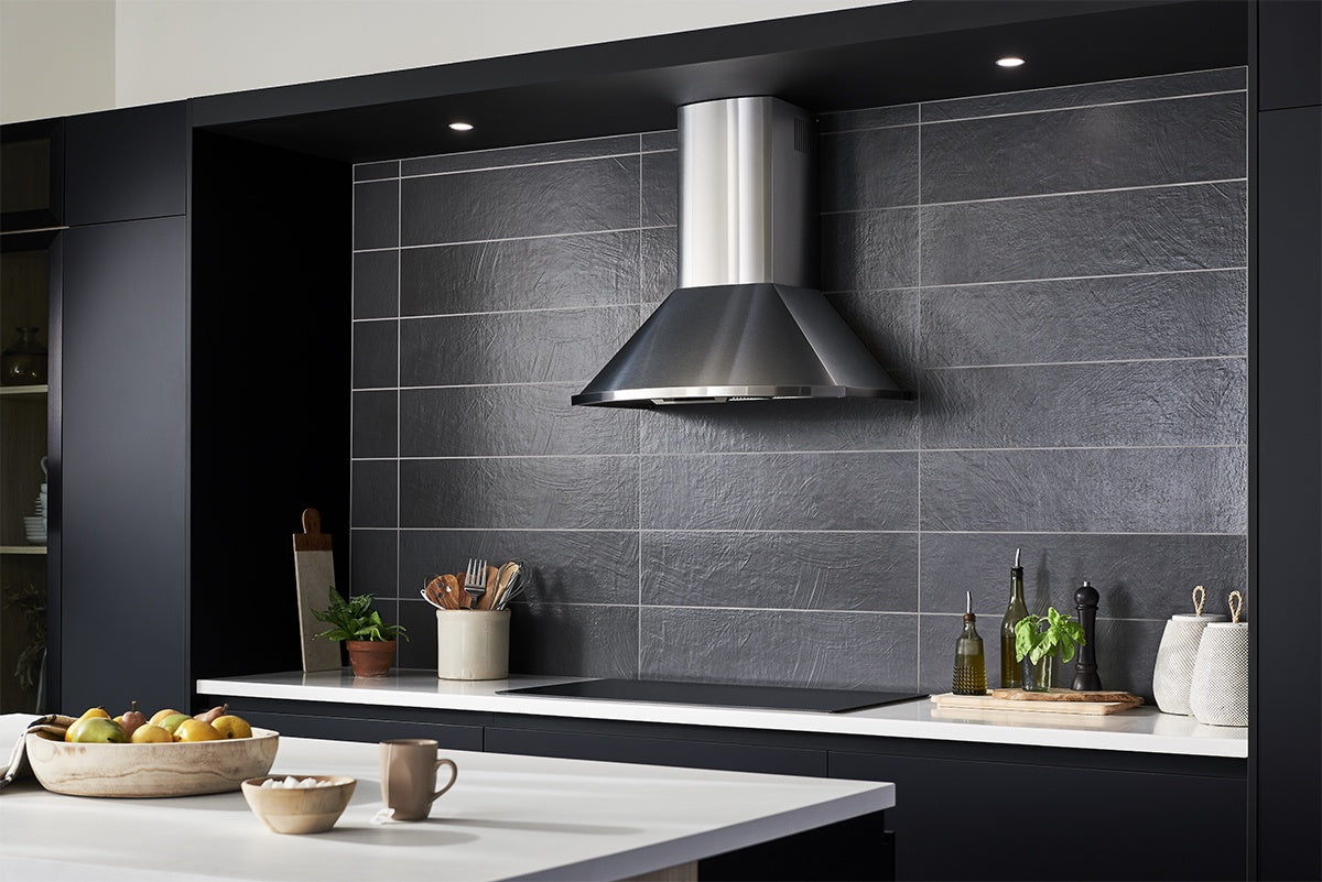 8" x 32" wall tile in the color Carbone, set in a black and white themed kitchen.