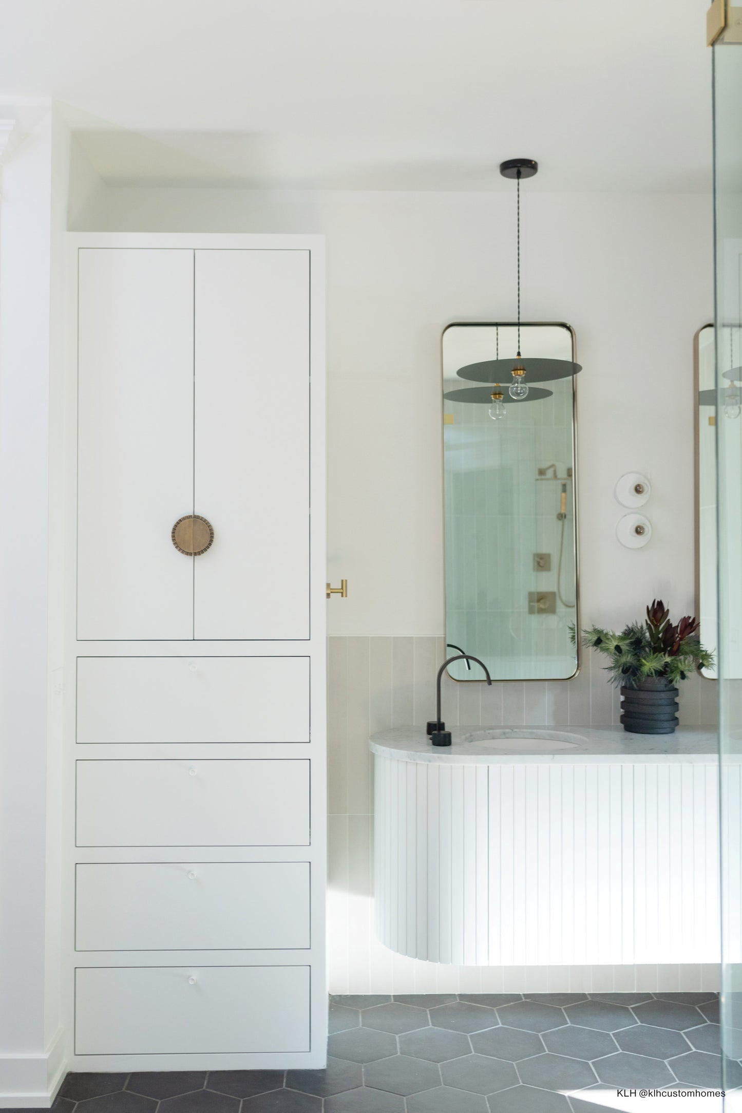 Grey field tile in vertical wall backsplash behind vanity.