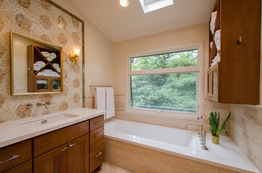 Remodeled Master Bathroom with Free-Standing Vanity tall framed glass floral mosaic backsplash and soaking tub under window