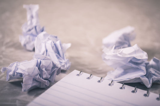 Crumpled Paper and Empty Notebook
