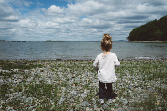 Girl on Beach Looking Over Water