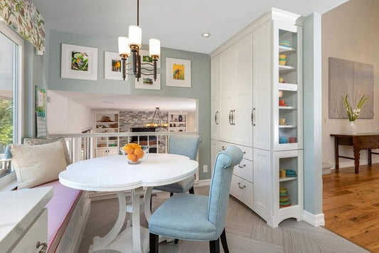 Remodeled Kitchen with White Painted Cabinets with Window Seat