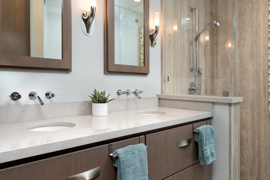 Remodeled master bathroom with custom vanity and travertine look porcelain slab shower