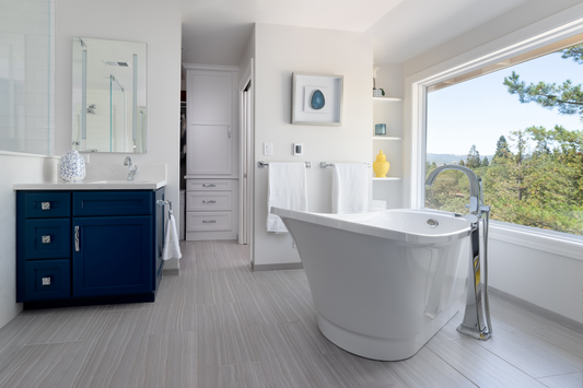 Remodeled Walnut Creek California bathroom with freestanding tub, blue painted vanities and cabinets, white painted cabinets, and open shelves