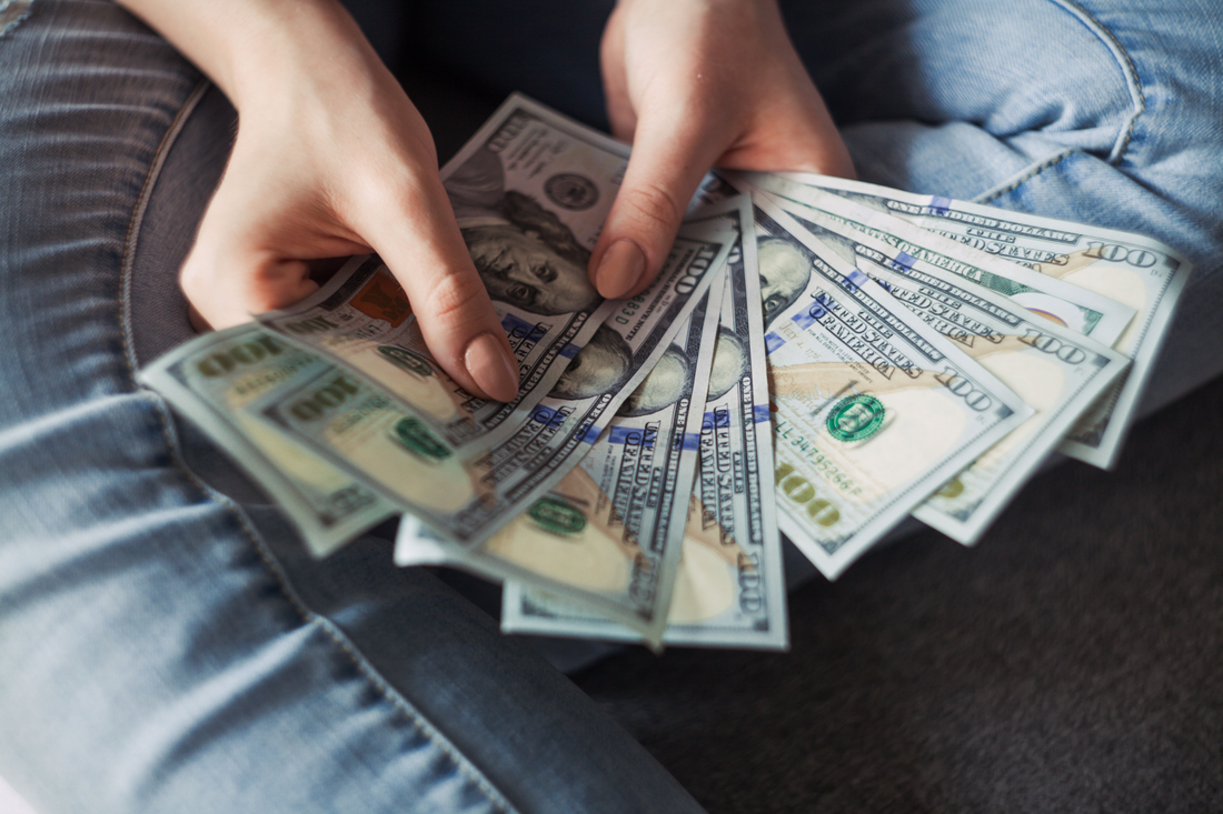 Photo of woman's hands holding money