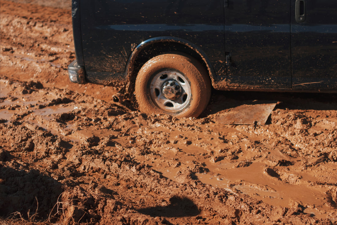 Picture of car tire stuck in the mud