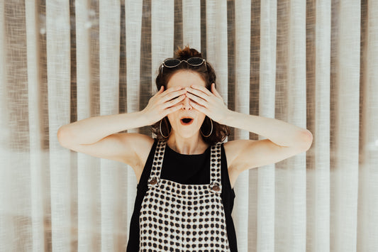 Photo of woman covering her eyes for a surprise
