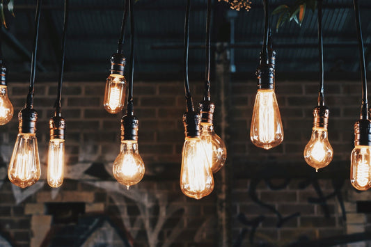 Series of Lit Edison Bulbs in Front of Brick Wall