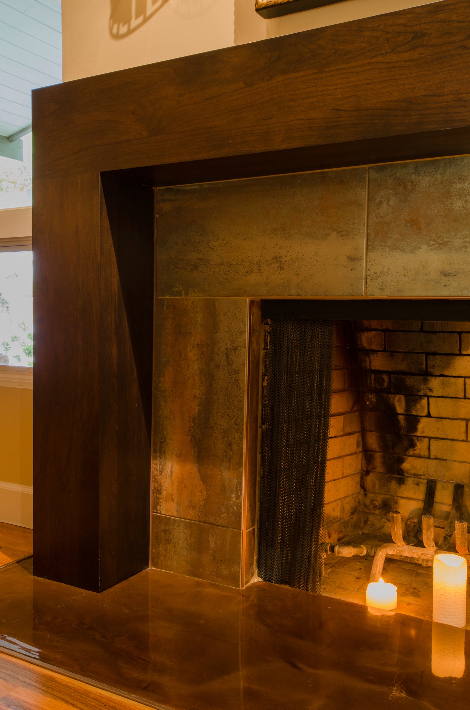 Close-up of a modern fireplace with custom wooden mantel.
