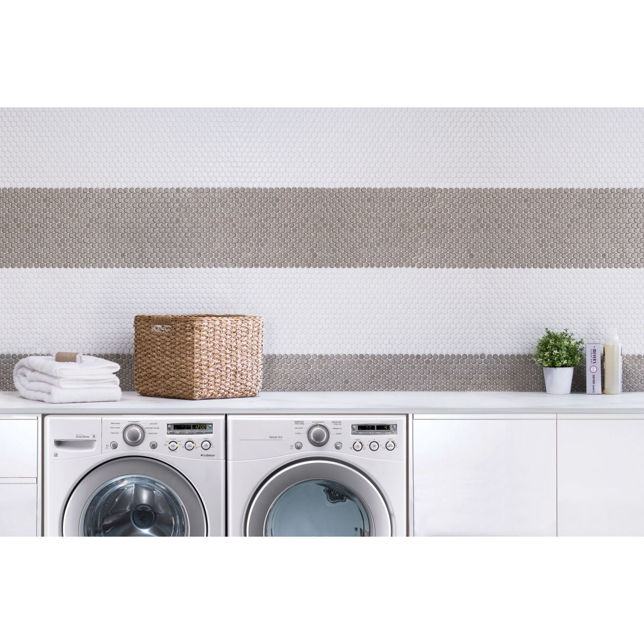 Laundry room with beige and white penny rounds as wall tile. 