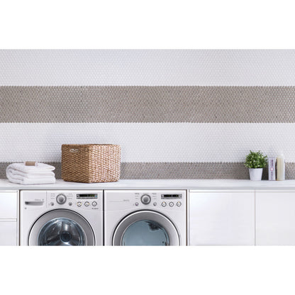 Laundry room with beige and white penny rounds as wall tile. 