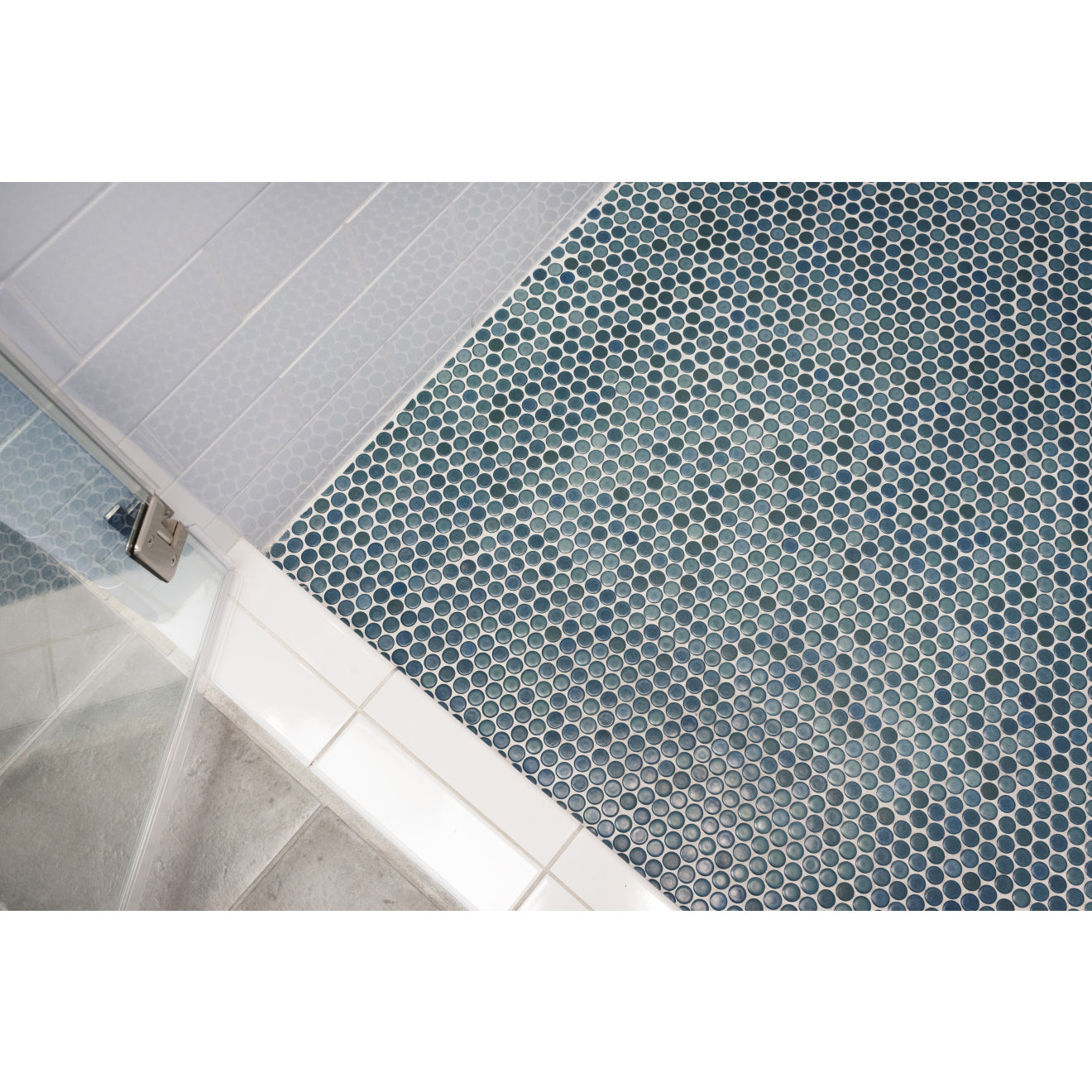 Shale Green penny round tile lining shower floor.