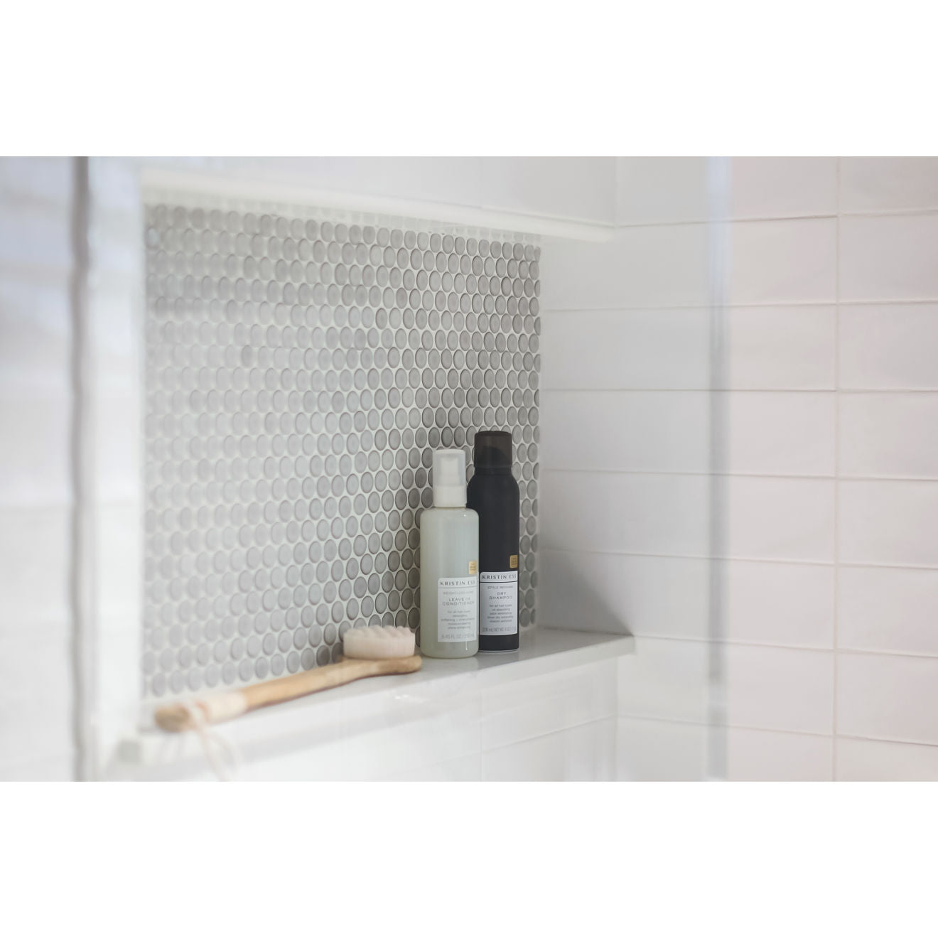 Pumice penny round tile used as a backsplash for a shower alcove. 