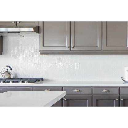 White and brown kitchen with Herringbone tile in the color White as a backsplash.