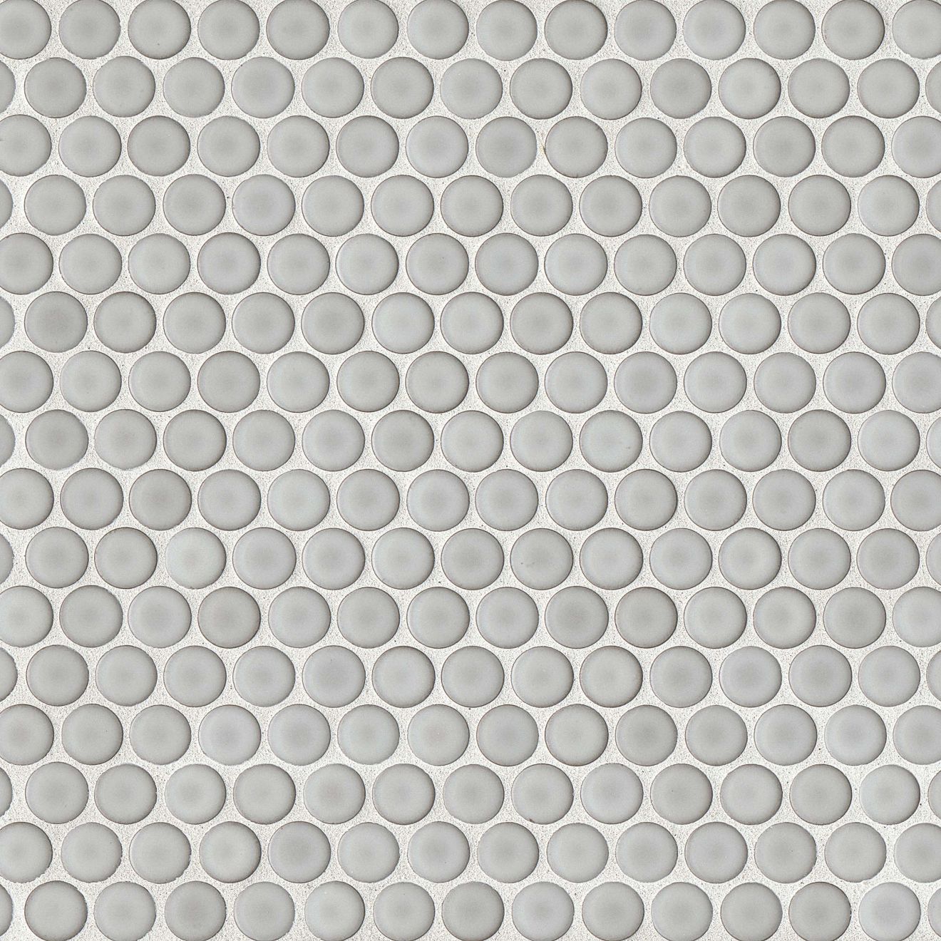 Dove grey penny shaped mosaic tile on a beige background.