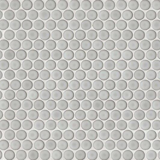 Dove grey penny shaped mosaic tile on a beige background.