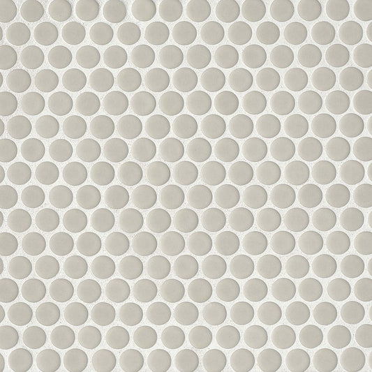 Off white penny shaped mosaic tile on a beige background.