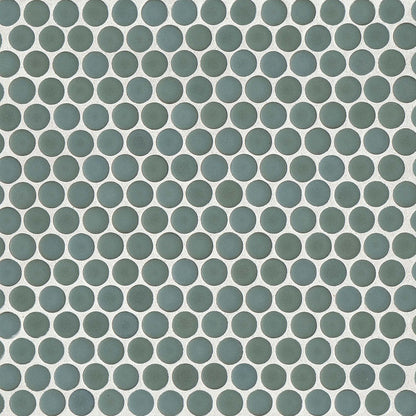 Silver sage green penny shaped mosaic tile on a beige background.