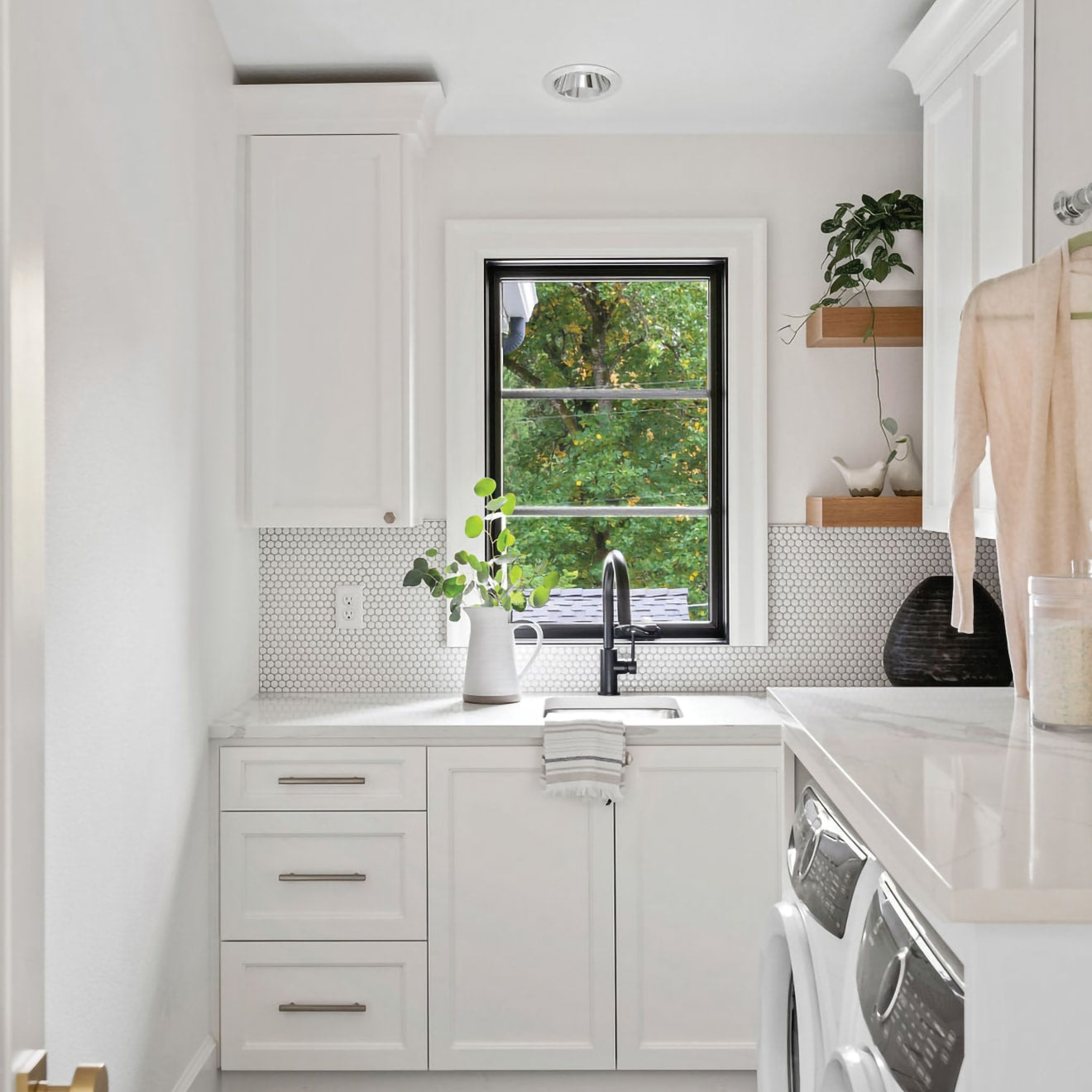 White penny round backsplash in laundry room.