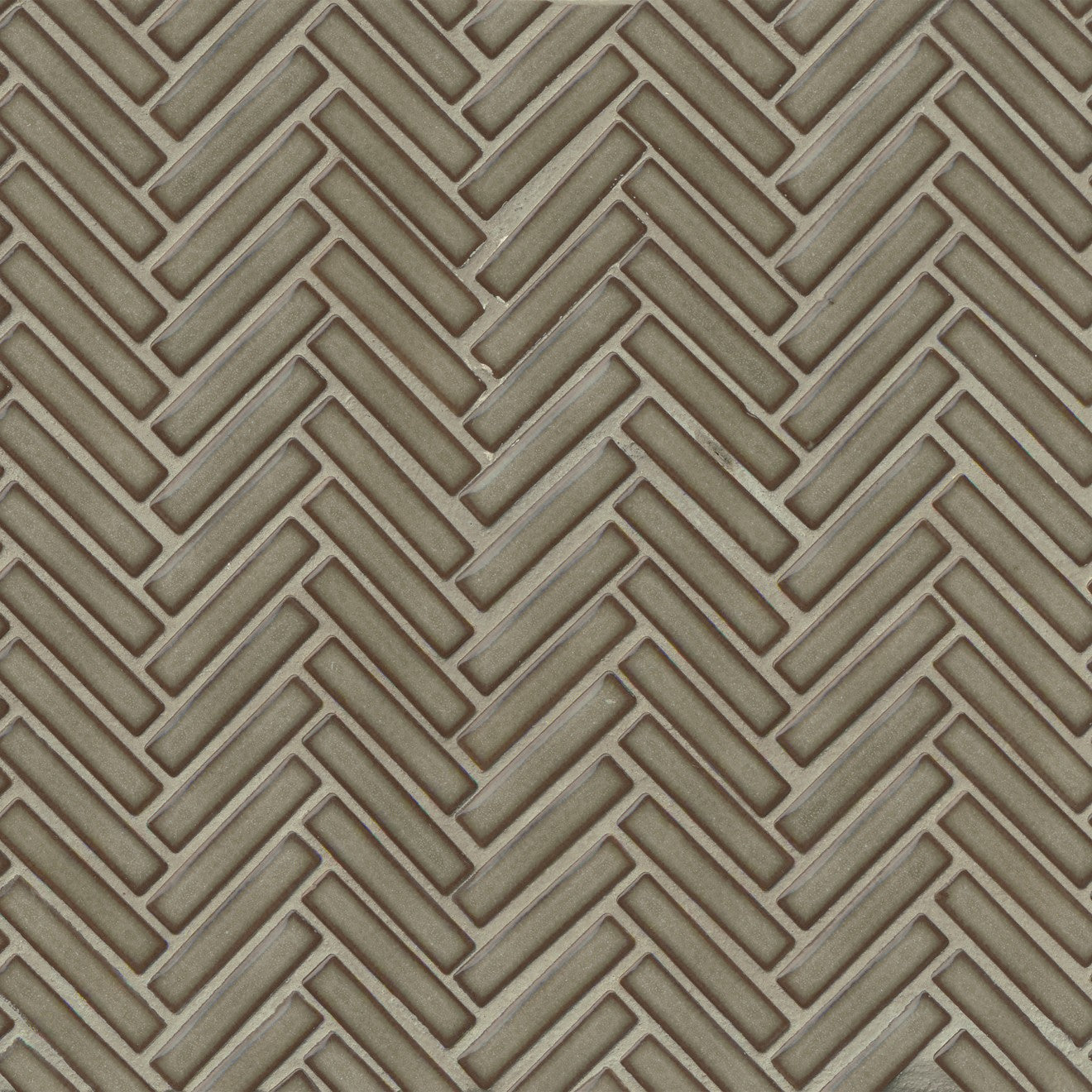 Herringbone tile in the color Grey Haze on a neutral background. 