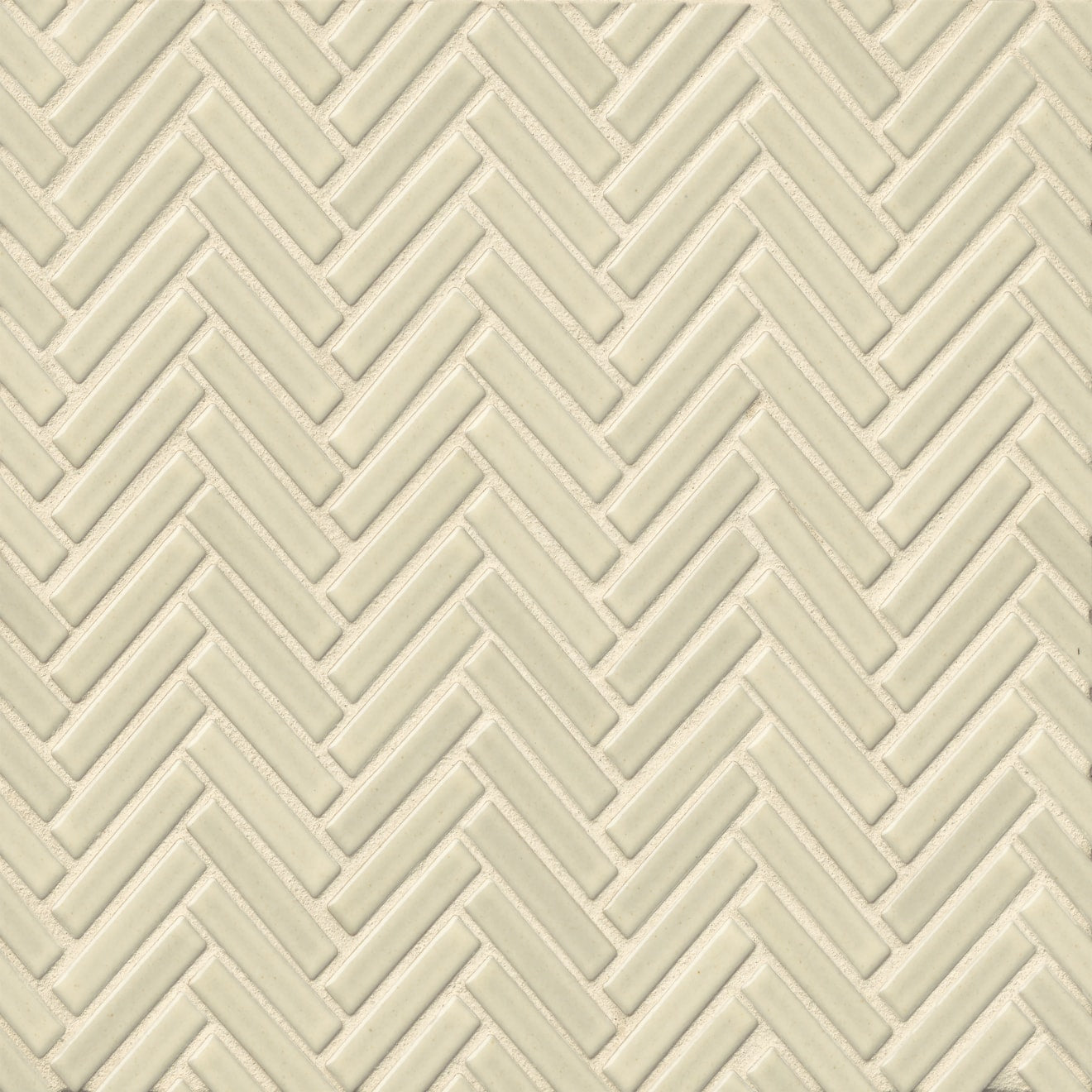 Herringbone tile in the color Off White on a neutral background. 