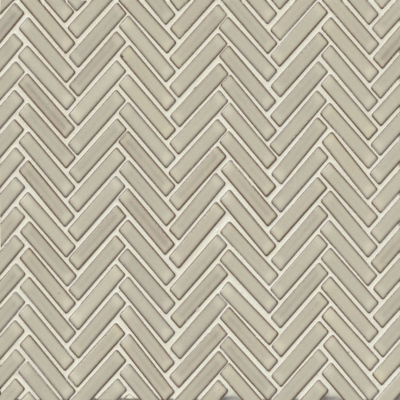 Herringbone tile in the color Putty on a neutral background. 